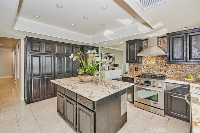 5386 Harter Ln, La Canada Flintridge, CA 91011 - kitchen featuring high end stainless steel range oven, wall chimney exhaust hood, a raised ceiling, backsplash, and light tile patterned floors