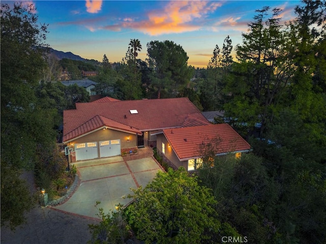 5386 Harter Ln, La Canada Flintridge, CA 91011 - view of front of house with a tile roof, driveway, a garage, and stucco siding