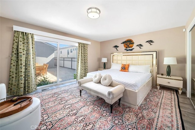 bedroom featuring light wood-type flooring and access to exterior