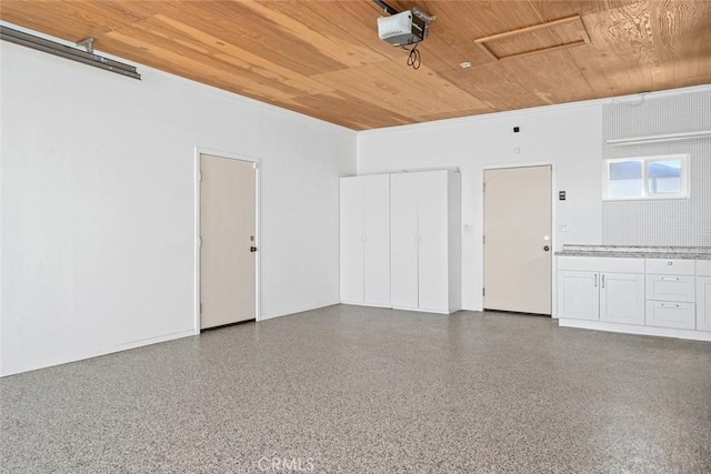 garage with wood ceiling and a garage door opener