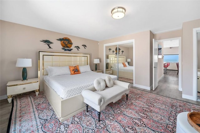bedroom featuring light wood finished floors, a closet, and baseboards
