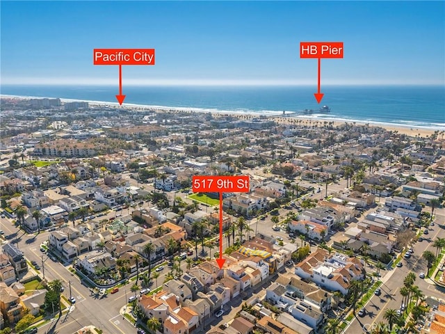 birds eye view of property with a view of the beach, a water view, and a residential view