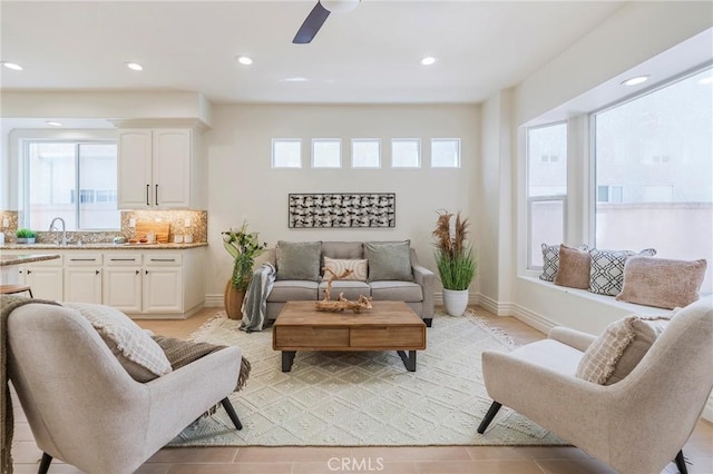 living room with recessed lighting, plenty of natural light, baseboards, and ceiling fan