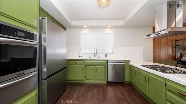 kitchen featuring appliances with stainless steel finishes, light countertops, island exhaust hood, and green cabinetry