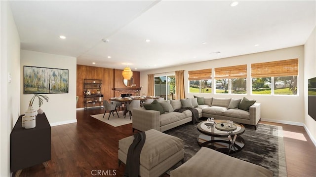 living room with baseboards, dark wood-type flooring, plenty of natural light, and recessed lighting