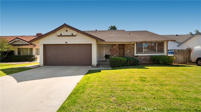 single story home with concrete driveway, brick siding, an attached garage, and a front yard