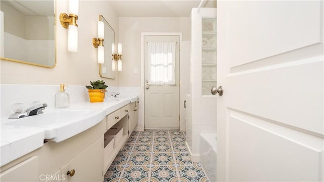 bathroom with double vanity, a bathing tub, a sink, walk in shower, and tile patterned floors