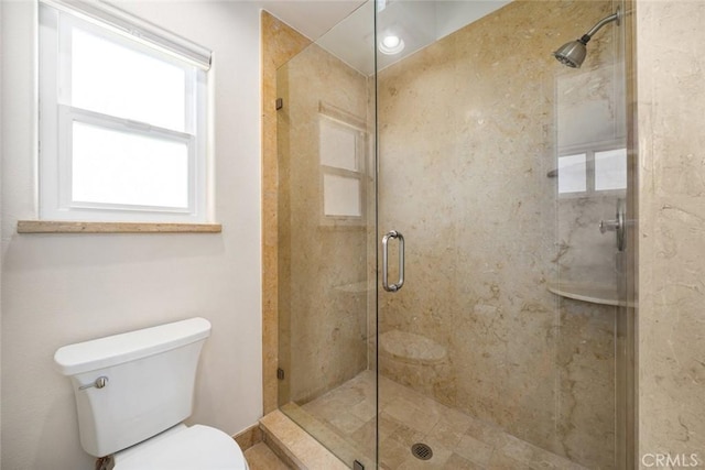 full bath featuring a stall shower and toilet