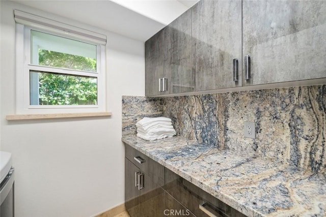 interior space featuring backsplash and vanity