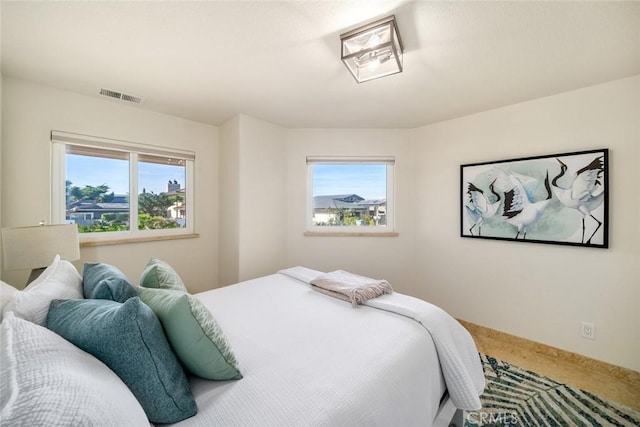 bedroom with visible vents and baseboards