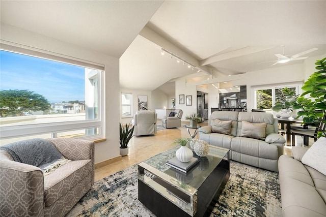 living room with vaulted ceiling, a ceiling fan, rail lighting, and baseboards