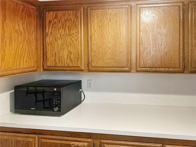 room details featuring brown cabinets and light countertops