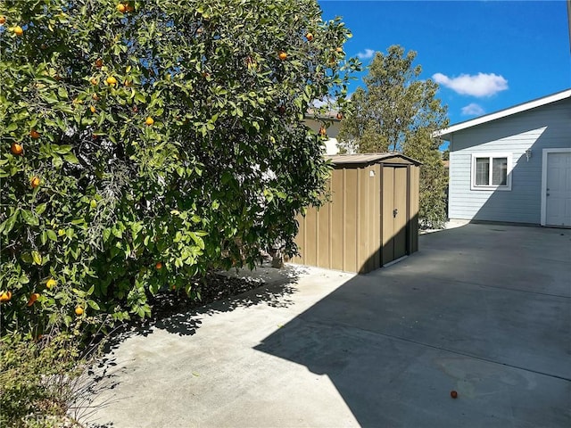 view of patio / terrace with an outbuilding and a shed