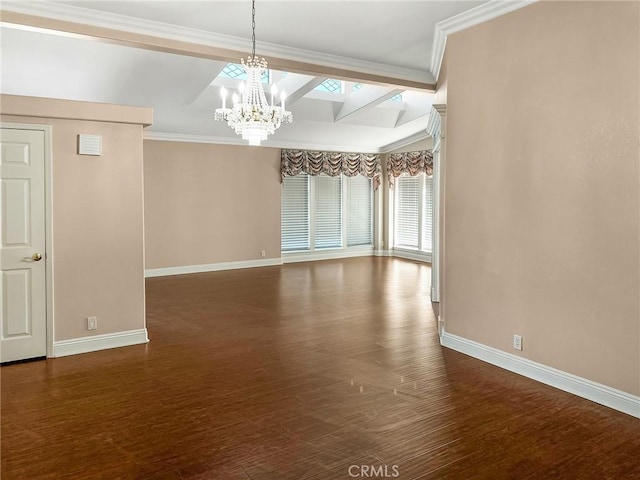 spare room featuring baseboards, dark wood finished floors, and crown molding