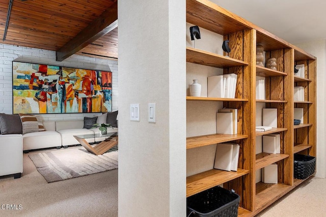 interior space featuring wooden ceiling, carpet flooring, and beam ceiling