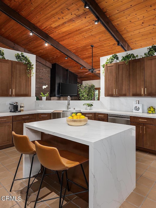 kitchen featuring a center island, wooden ceiling, and a kitchen breakfast bar