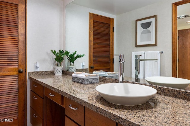 bathroom with a closet and vanity