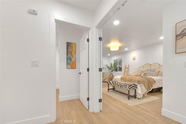 bedroom with light wood-style floors, recessed lighting, and baseboards