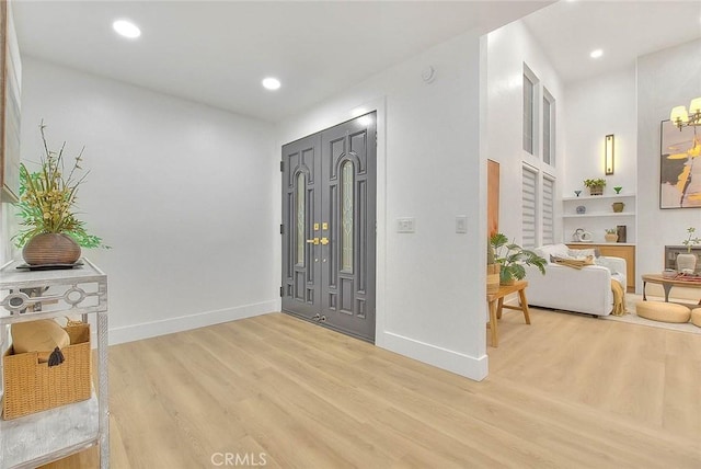 entrance foyer with recessed lighting, baseboards, and wood finished floors