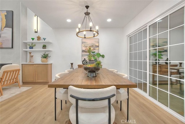 dining room with recessed lighting, a notable chandelier, and light wood finished floors