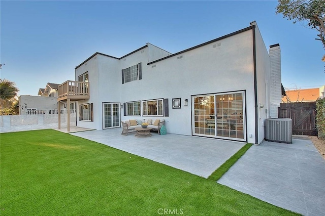 back of house with central AC unit, outdoor lounge area, fence, and a balcony