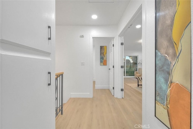 hall with light wood-type flooring, baseboards, and recessed lighting