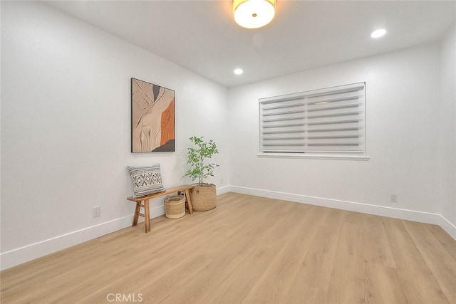 interior space featuring recessed lighting, wood finished floors, and baseboards