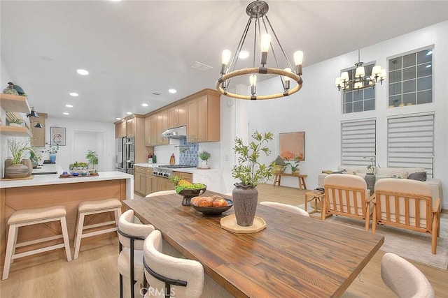 dining room with light wood-style floors, a chandelier, and recessed lighting