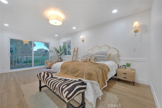 bedroom with light wood-type flooring, baseboards, and recessed lighting