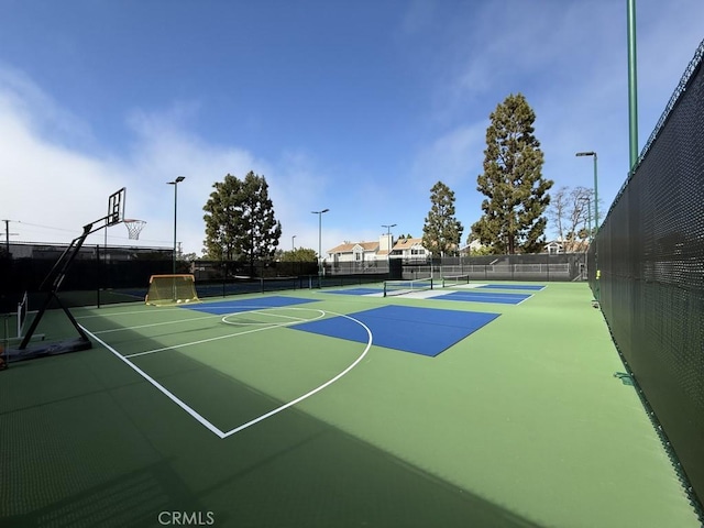 view of basketball court featuring community basketball court and fence