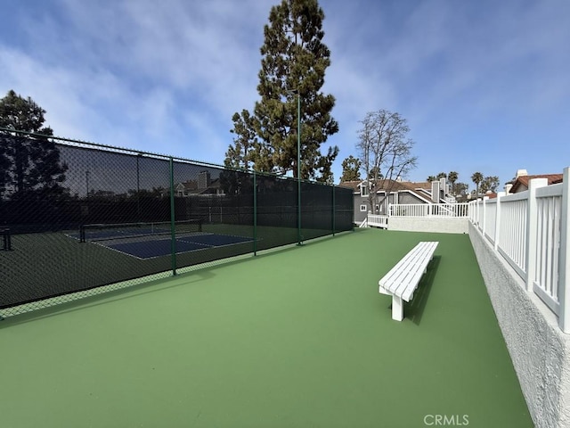 view of sport court featuring fence