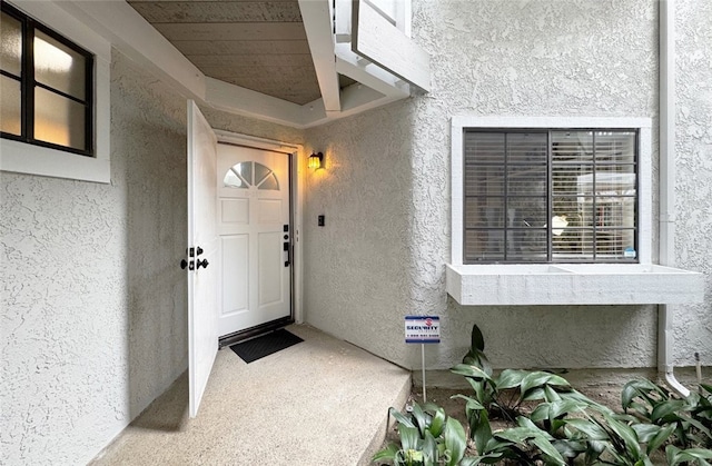 doorway to property with stucco siding