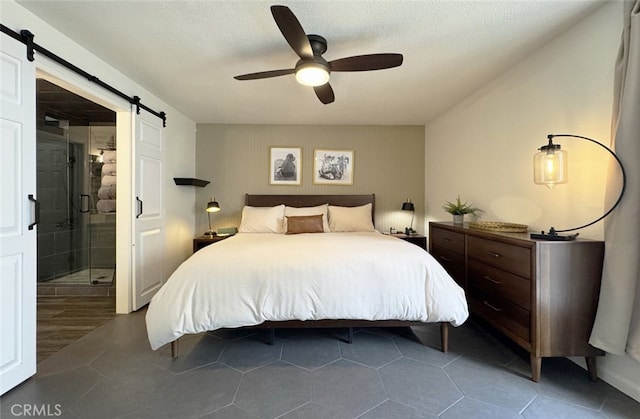 tiled bedroom with ceiling fan, a textured ceiling, and a barn door