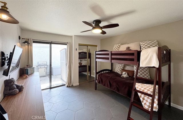 bedroom featuring baseboards, a ceiling fan, access to outside, a textured ceiling, and a closet