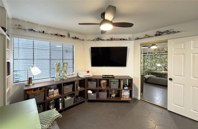 tiled living area with a ceiling fan