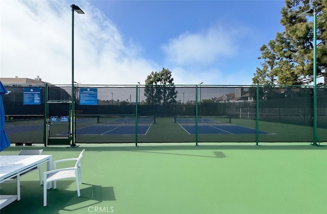 view of sport court with fence