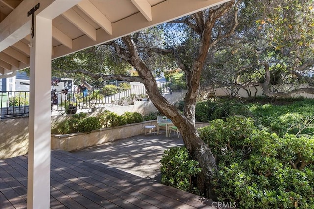 view of patio with fence and a deck