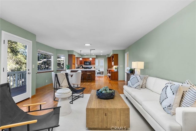 living room with light wood finished floors and recessed lighting