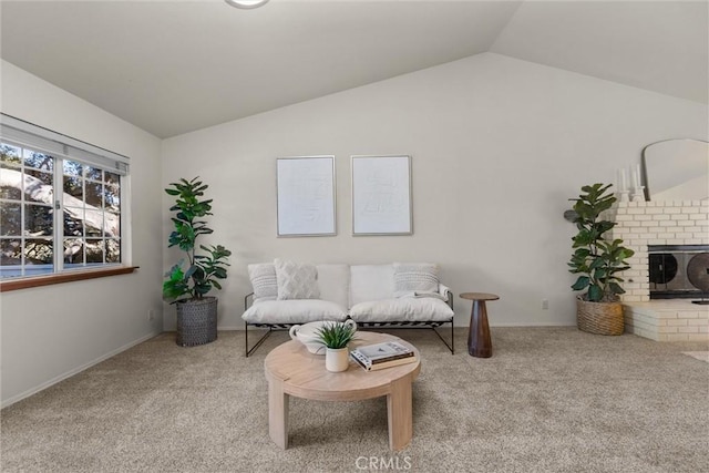 living room with lofted ceiling, a fireplace, carpet flooring, and baseboards