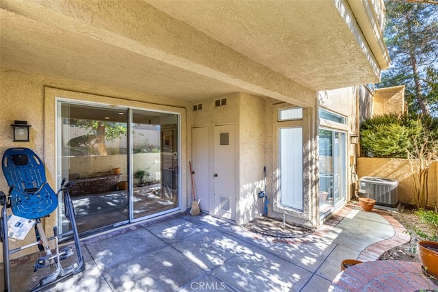 view of patio / terrace with visible vents, fence, and central AC unit