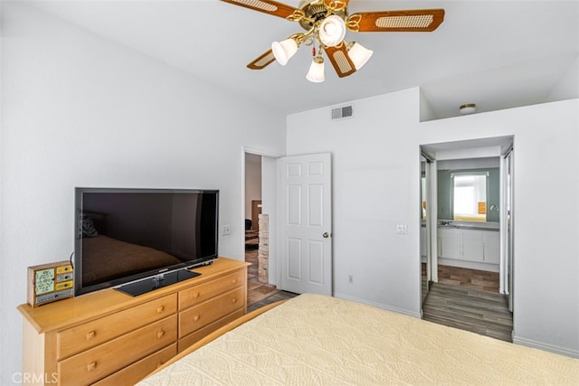 bedroom with a ceiling fan, visible vents, baseboards, and wood finished floors