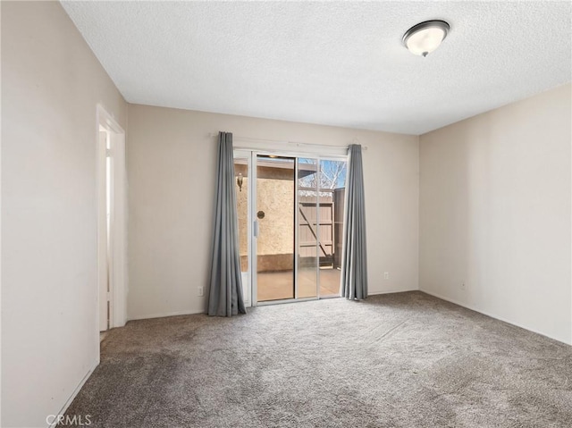 carpeted spare room with a textured ceiling