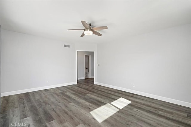 unfurnished room with wood finished floors, visible vents, and baseboards