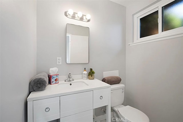 bathroom featuring toilet and vanity