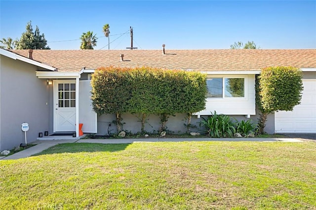 single story home featuring a garage, a front lawn, a shingled roof, and stucco siding