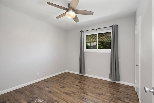 unfurnished room featuring ceiling fan, baseboards, and wood finished floors