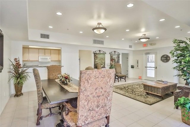 dining area with light tile patterned floors, visible vents, and recessed lighting