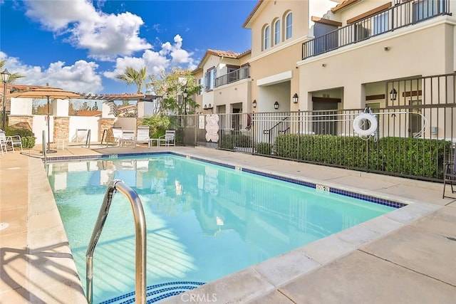 community pool with a residential view and fence