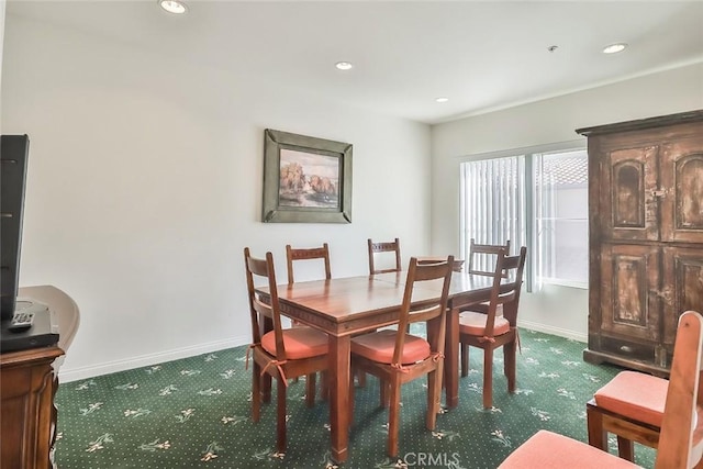 dining area featuring dark colored carpet, baseboards, and recessed lighting