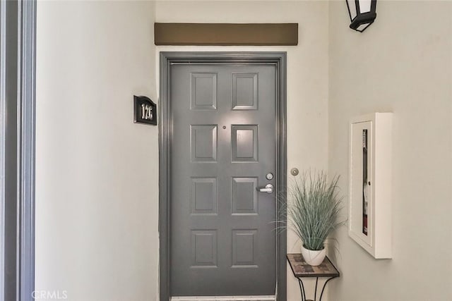 property entrance featuring stucco siding